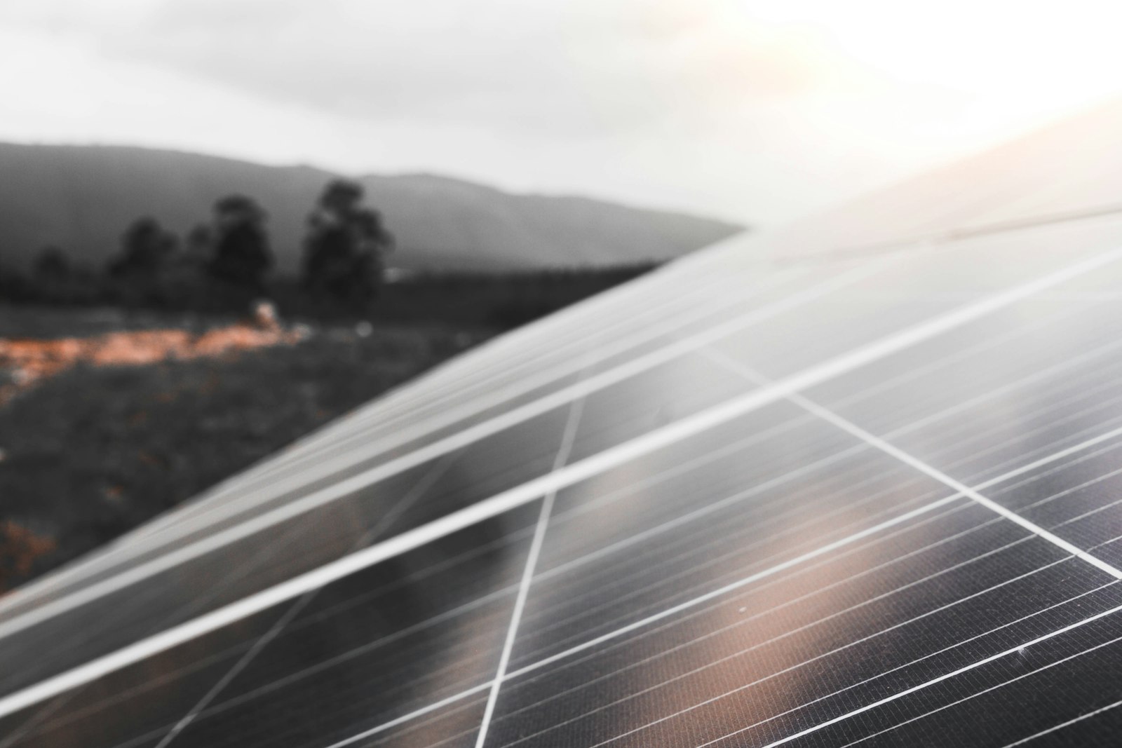 Solar module surface with the sun breaking through clouds