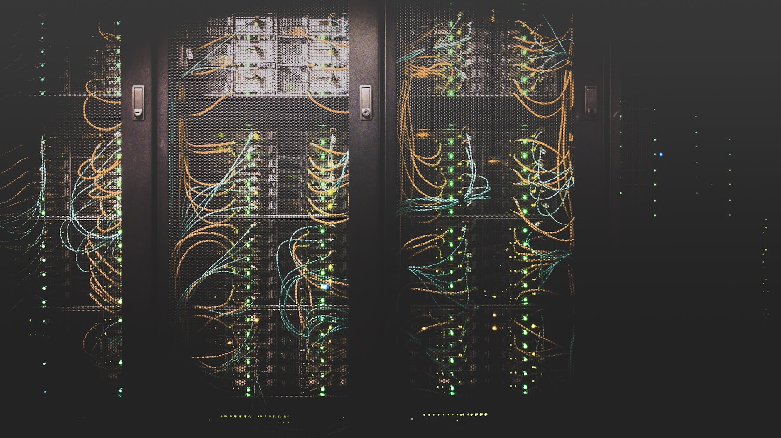 Server racks with network cabling in a dark data center